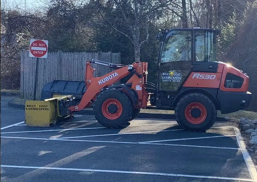 Loader plowing a commercial parking lot for Billy Goat Landscaping