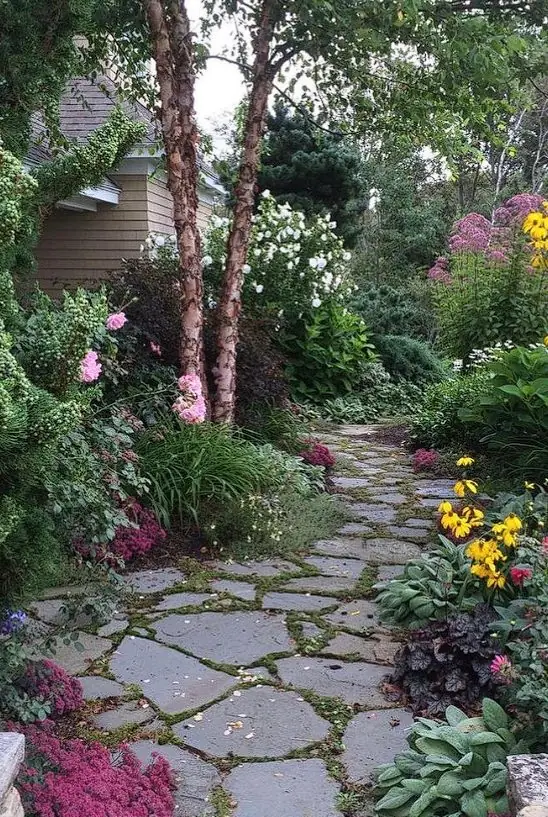 Flagstone path through a colorful flower garden in Kennebunk, Maine