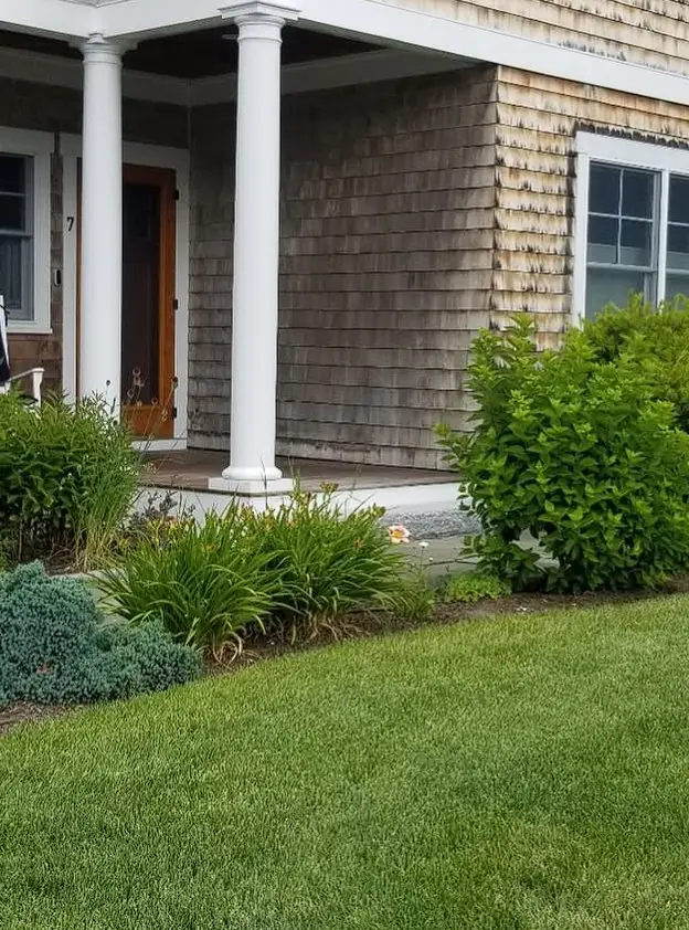 Foundation plantings along a covered porch, Southern Maine landscaping