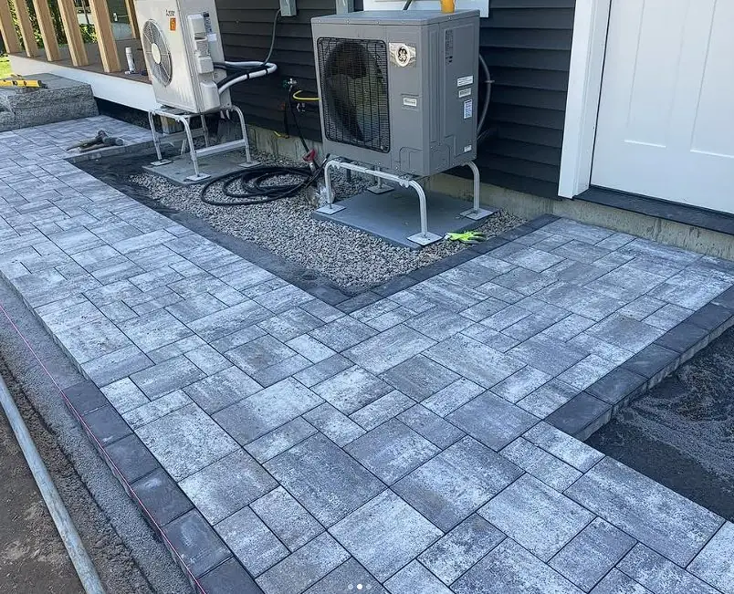 Paver patio built around outdoor mechanical equipment in Maine