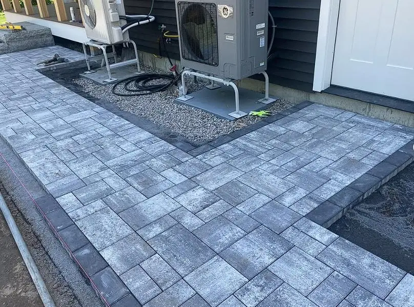 Paver patio installed around outdoor mechanical equipment by Billy Goat Landscaping