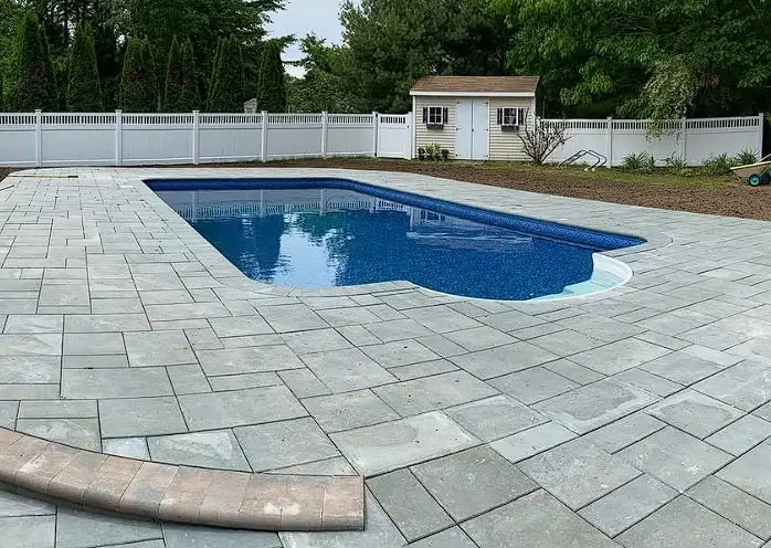 Paver pool surround installed by Billy Goat Landscaping in Southern Maine