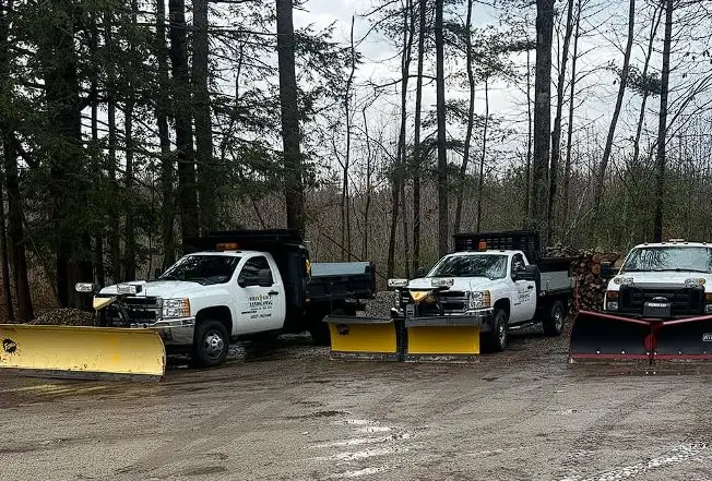 Billy Goat Landscaping's snow plow truck fleet staged for a Maine winter storm