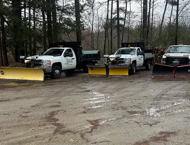 Billy Goat Landscaping's snow plow truck fleet staged for a Maine winter storm