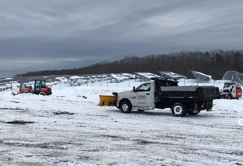 Billy Goat Landscaping snow removal equipment clearing a commercial lot